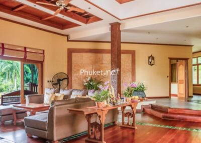 Spacious living room with wooden accents and outdoor view