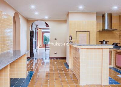 Well-lit kitchen with modern appliances and tiled flooring