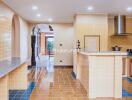 Well-lit kitchen with modern appliances and tiled flooring