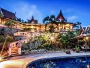 Exterior view of a luxury property with a swimming pool at dusk