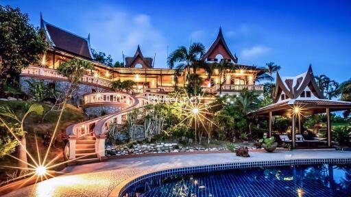 Exterior view of a luxury property with a swimming pool at dusk