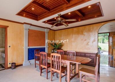 Elegant dining room with wooden ceiling and modern lighting