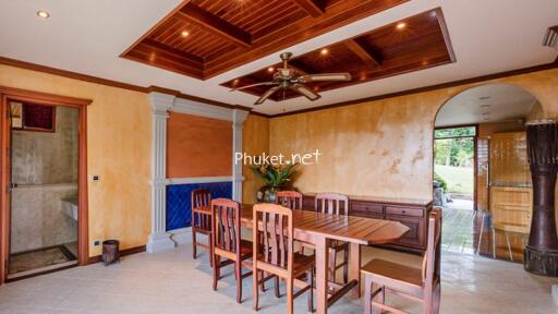 Elegant dining room with wooden ceiling and modern lighting