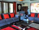 Modern living room with blue sofas and red cushions