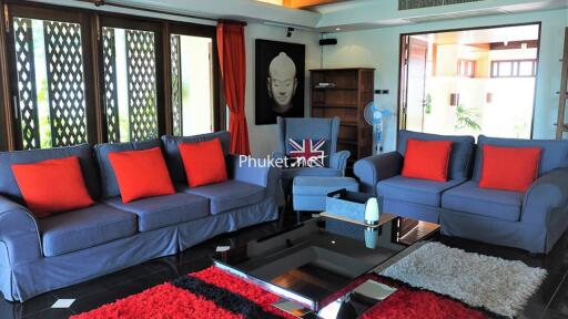 Modern living room with blue sofas and red cushions