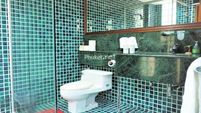 Modern bathroom with green and blue tiled walls