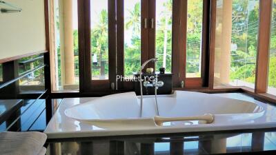 Modern bathroom with large bathtub and window view