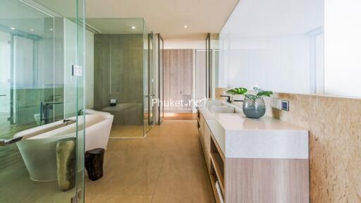 Modern bathroom with glass shower, bathtub, and double sinks