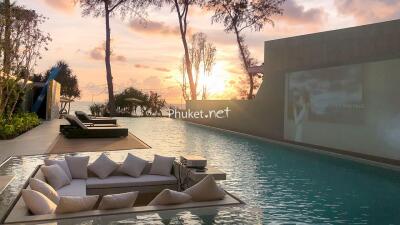 Outdoor pool area with submerged seating and sunset view