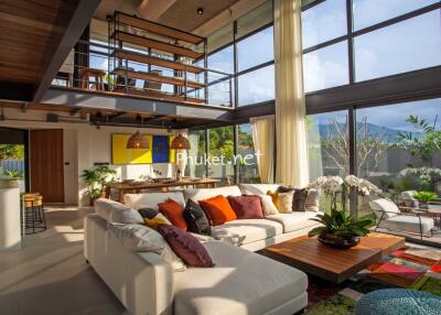 Spacious and modern living room with large windows and comfortable seating