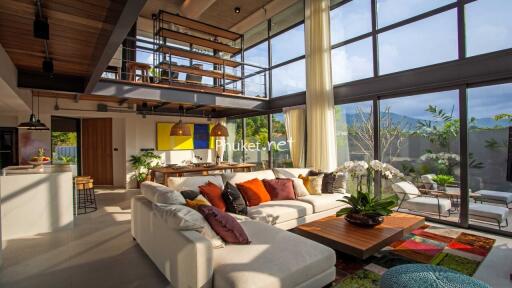 Spacious and modern living room with large windows and comfortable seating