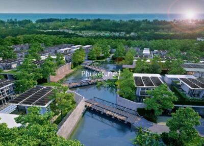 Aerial view of modern residential complex with solar panels and green surroundings