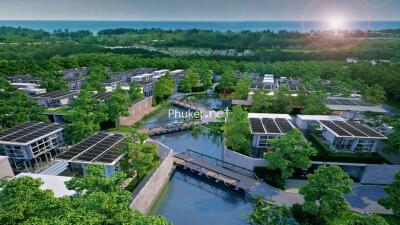 Aerial view of modern residential complex with solar panels and green surroundings