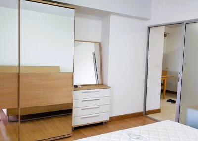 Bedroom with wardrobe, dresser, and mirror