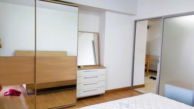 Bedroom with wardrobe, dresser, and mirror