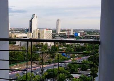 View from the balcony overlooking the city skyline with buildings and greenery