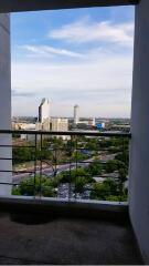 View from the balcony overlooking the city skyline with buildings and greenery