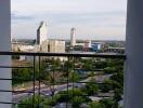 View from the balcony overlooking the city skyline with buildings and greenery