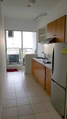 Small, narrow kitchen with cabinets, sink, stove, and refrigerator