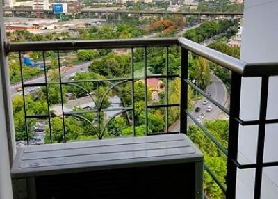 Photo of a balcony with a view of the city and greenery