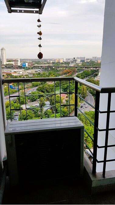 Photo of a balcony with a view of the city and greenery