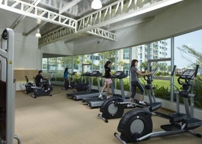 Gym with exercise equipment and people working out