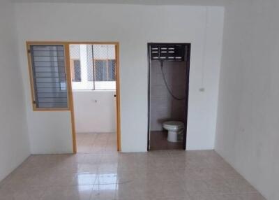 Bathroom and adjacent room with window in a residential property