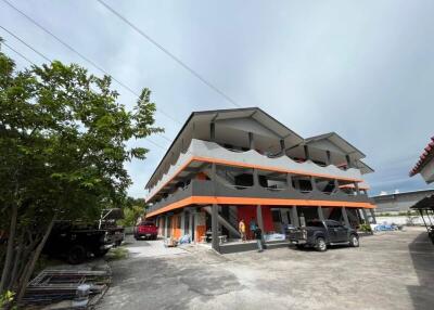 Multi-story residential building with parking area