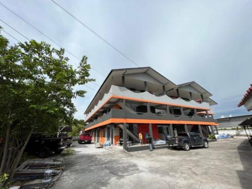 Multi-story residential building with parking area