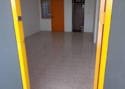 Entryway into a spacious living area with tiled flooring