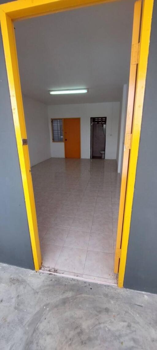 Entryway into a spacious living area with tiled flooring