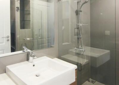 Modern bathroom with sink, mirror, and walk-in shower