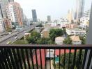 city view from balcony with buildings and greenery