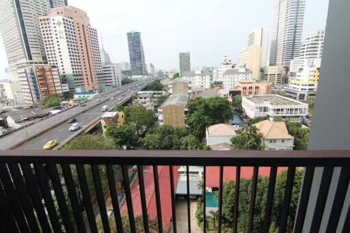 city view from balcony with buildings and greenery