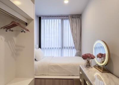 Modern bedroom with vanity and hanging storage
