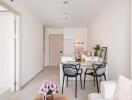 Modern dining area with table, chairs, and kitchen in contemporary apartment