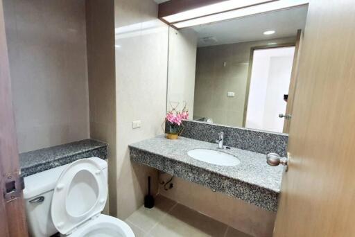 Bathroom with gray granite countertop and toilet