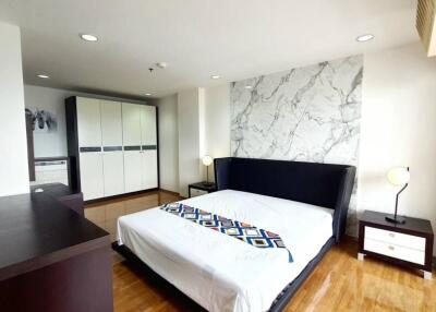 Spacious bedroom with modern decor and ample natural light