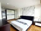 Spacious bedroom with modern decor and ample natural light