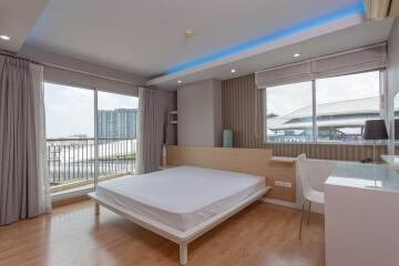 Modern bedroom with large windows and balcony