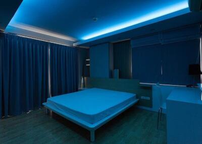 Modern bedroom with blue ambient lighting