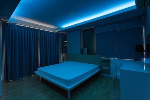 Modern bedroom with blue ambient lighting