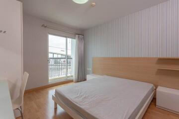 Modern bedroom with a large window offering natural light