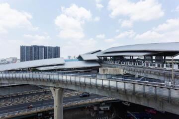 Urban infrastructure with an elevated train system and modern buildings in the background