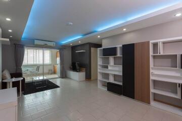 Modern living room with built-in shelves and LED lighting