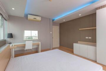 modern bedroom with air conditioning and workspace