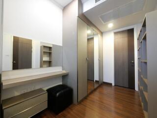 Modern bedroom with wooden flooring and mirrored wardrobe