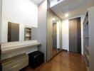 Modern bedroom with wooden flooring and mirrored wardrobe