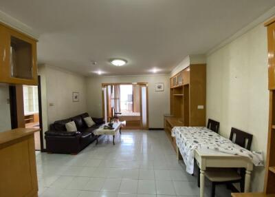 Spacious living room with sofas and a dining area