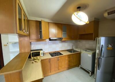 Spacious kitchen with wooden cabinets and modern appliances